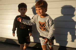Child Wearing Taniwha Tūturu Crew Neck Sweatshirt – grey